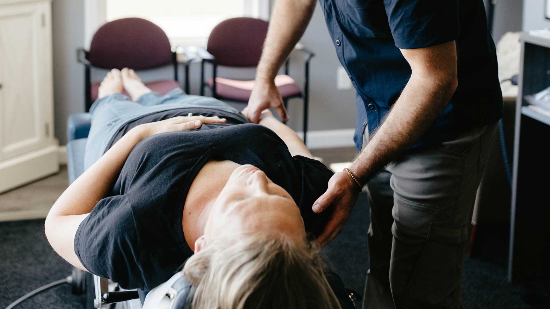 Dr. Miller performing an Applied Kinesiology (AK) assessment and adjustment on a patient with shoulder pain.