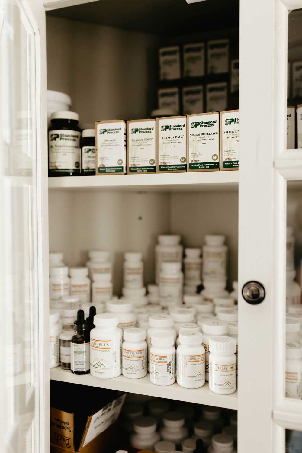 Bottles of Nutriwest supplements arranged on a shelf, offering a range of health support products.